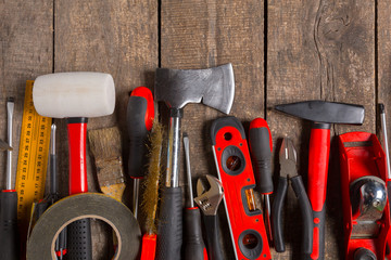 Assorted work tools on wood background