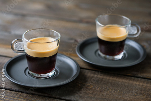 Cuadros en Lienzo Two cups of espresso on a wooden table