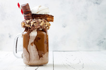 Chocolate Indulgent Exreme Milkshake With Brownie Cake, Marshmallow And Sweets. Crazy Freakshake Food Trend. Copy Space