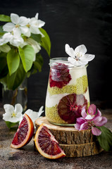 Wall Mural - Detox layered matcha green tea chia seed pudding with blood oranges. Vegan dessert with coconut whipped cream. Healthy vegetarian breakfast, dieting, weight loss food