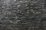 Fototapeta Kamienie - Серо чёрная каменная текстура из кирпичной стены частного дома