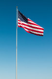 Fototapeta Morze - American Flag with the background of a blue sky.  