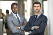 © elnariz - Business partners, possibly attorneys or lawyers standing at the office business workplace