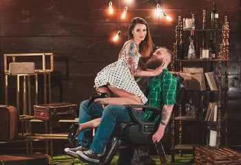 Barber girl shaves the bearded man.