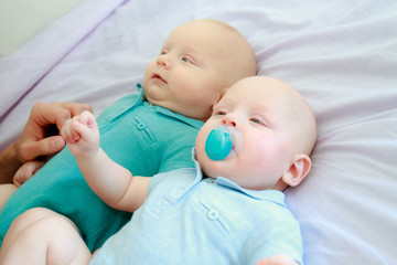 indoor portrait of two young baby twins at home