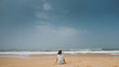 © Oleg Samoylov - Girl looks at the ocean sitting on the sand