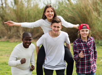 Happy teenage friends in park.