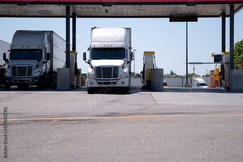 Fotografie, Obraz Semi Trucks are at the gas station for refueling
