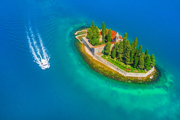 Top view of the island with a monastery in the blue sea