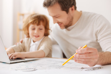 Focused photo on pencil that being in male hand