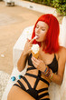 © Mikalai Bachkou - Cute girl in sexy bikini eat icecream cone.