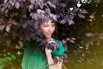 redhead cute girl in purple or brown leaves portrait