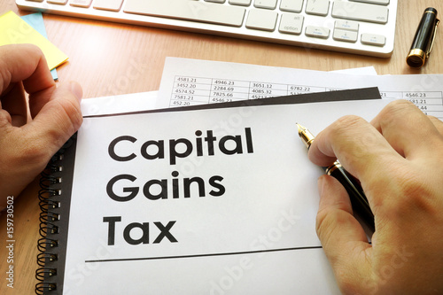 Fotomural Hands holding documents with title capital gains tax CGT.