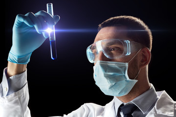 Canvas Print - scientist with safety glasses, mask and test tube