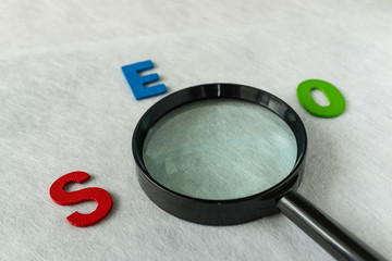 Aufkleber - search engine optimization concept as alphabet abbreviation seo and magnification glass