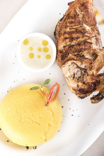 Chicken Half Breast And Wing With Polenta And Garlic Sauce “mujdei”, Decorated With Fresh Leafs, Light Background, Isolated