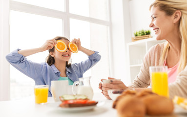 Poster - happy family having breakfast at home kitchen