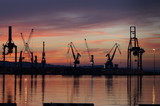 Fototapeta Most - The romantic landscape of seaport in the Golden sunset hour.
