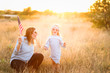 © MeganBetteridge - Patriotic mother and daughter with American flag