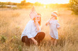 © MeganBetteridge - Patriotic mother and daughter with American flag