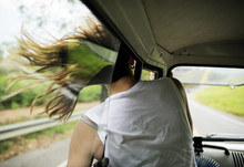 Woman Sitting In A Car Put Head Out Of Window Wind Blowing Her Hair