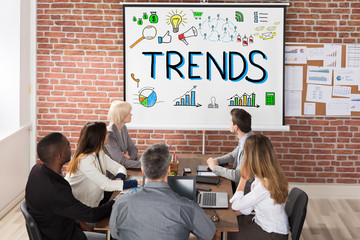 Wall Mural - Businesspeople Looking At Trends Presentation