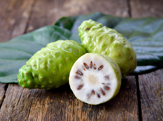 Wall Mural - noni fruit on wooden background