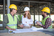 mature builders and contractor talking during work on construction site