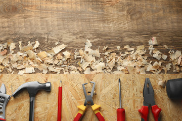 Sticker - Set of carpenter's tools and saw dust on wooden table