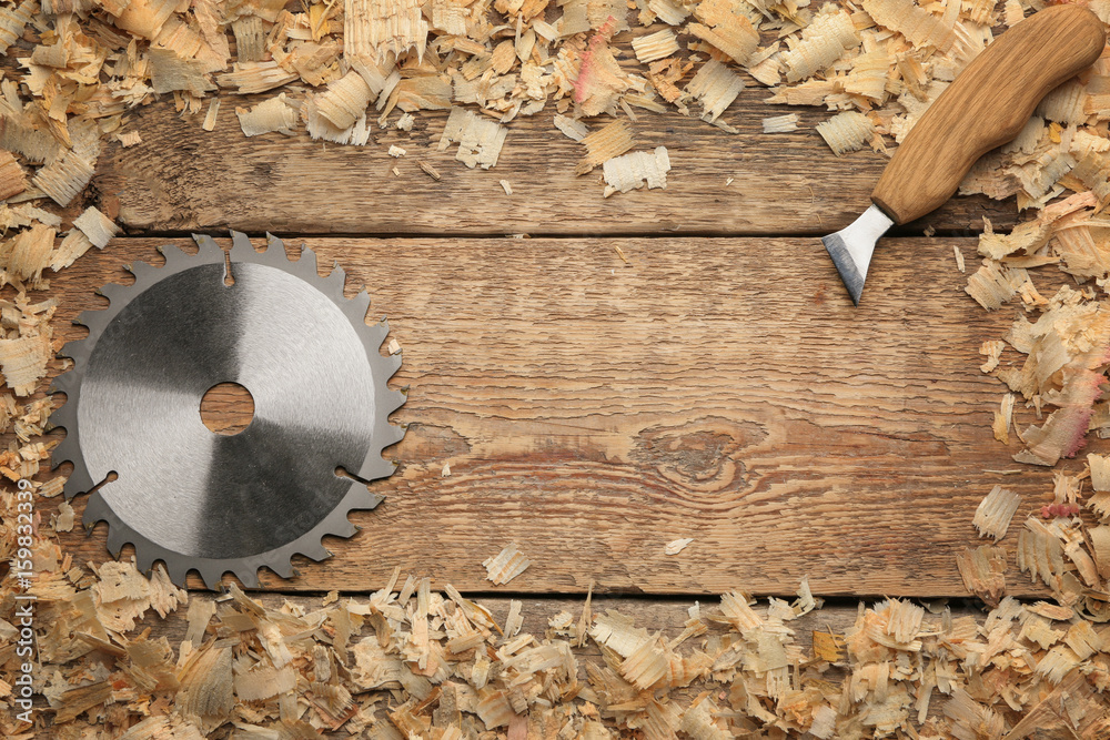 Carpenter's tools and frame made of saw dust on wooden background