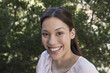 © Westend61 - Portrait of smiling young woman outdoors