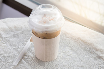 Cool coffee in plastic glass