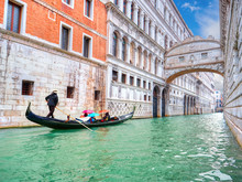 Traditional Gondola And The Famous Bridge Of Sighs In Venice