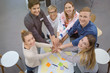 © contrastwerkstatt - motivierte leute in einem workshop halten die hände zusammen