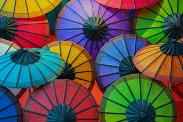 colorful paper umbrellas on store shelves. laos
