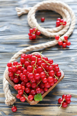 Wall Mural - Red currant in a wooden bowl.