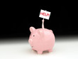 © Michael O'Keene - Pink piggy bank with man inside holding up HELP! sign representing financial advice, marketing consultant, stock broker, bankruptcy, crisis, debt, savings, banking services, credit problems, no money.