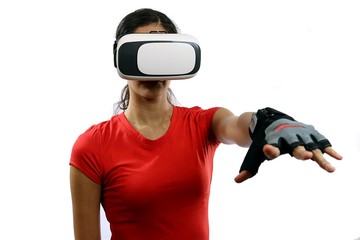 Young attractive woman wearing virtual reality goggles and remote control glove