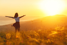 Happy Woman Standing With Her Back On Sunset In Nature Iwith Open Hands.