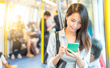 Poster - Woman working on mobile phone inside train compartment