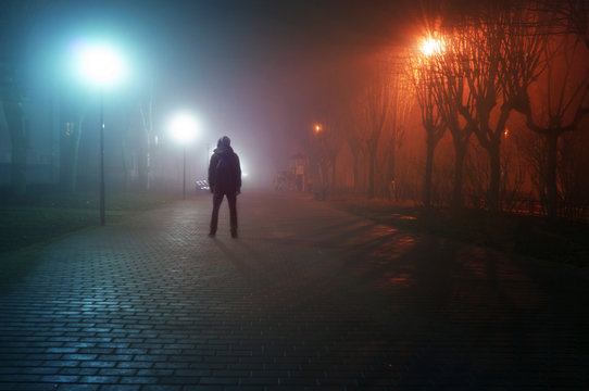 Fototapete - man stand alone at the foggy street