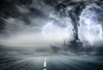 Wall Mural - powerful tornado on road in stormy landscape