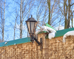 Wall Mural - Fragment of fence with small lantern.