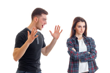 young couple in quarrel faces in the Studio, turning away from each other and the guy screams