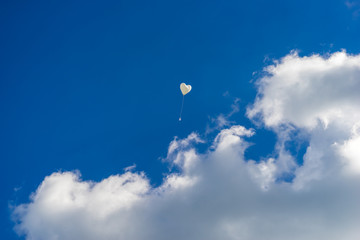 heart balloon flying into the sky