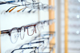 Fototapeta Mapy - in optician shop- different  glasses for sale in wall rack
