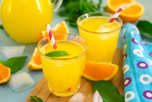 Sweet orange drink with ice and mint leaves