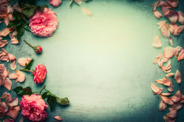  Flowers frame made of pink roses with petals and leaves on turquoise  shabby chic background, top view, retro toned