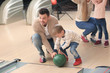 © Africa Studio - Family having fun at bowling club