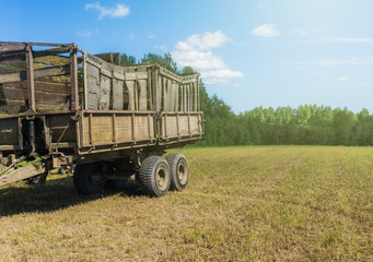 Old trailer with wooden beehives in the countryside